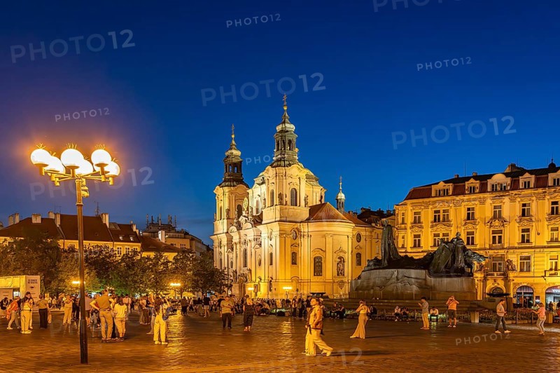 The Baroque St. Nicholas Church and the Jan Hus Memorial on Old Town Square at dusk, Prague, Czech Republic