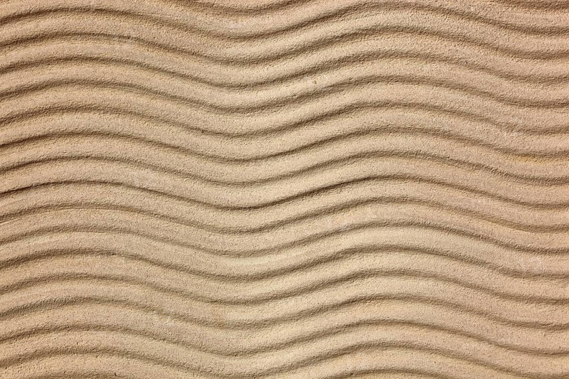 Beige sand with uniform wave patterns