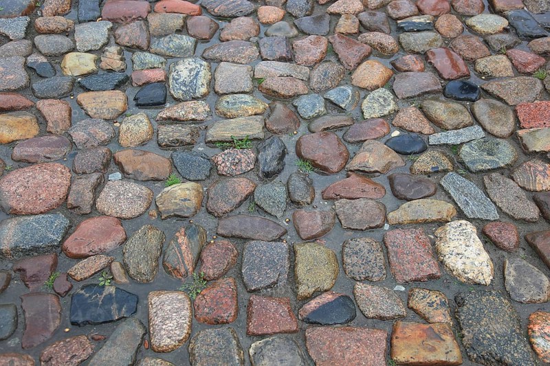 Wet cobblestones with irregular stones in natural earthy tones