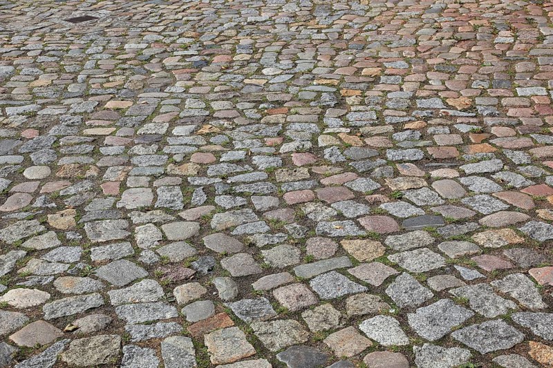 Rough cobblestone road with irregular arrangement of stones
