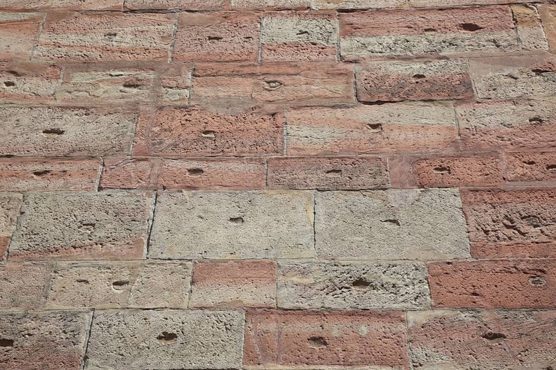 Textured brick wall in shades of red and brown with retro style