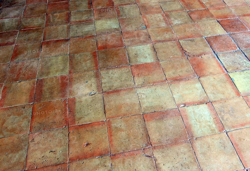 Rustic terracotta tiles with vivid earthy tones and square pattern