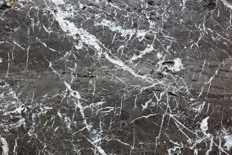 Black marble surface with white veins, exudes elegance and luxury