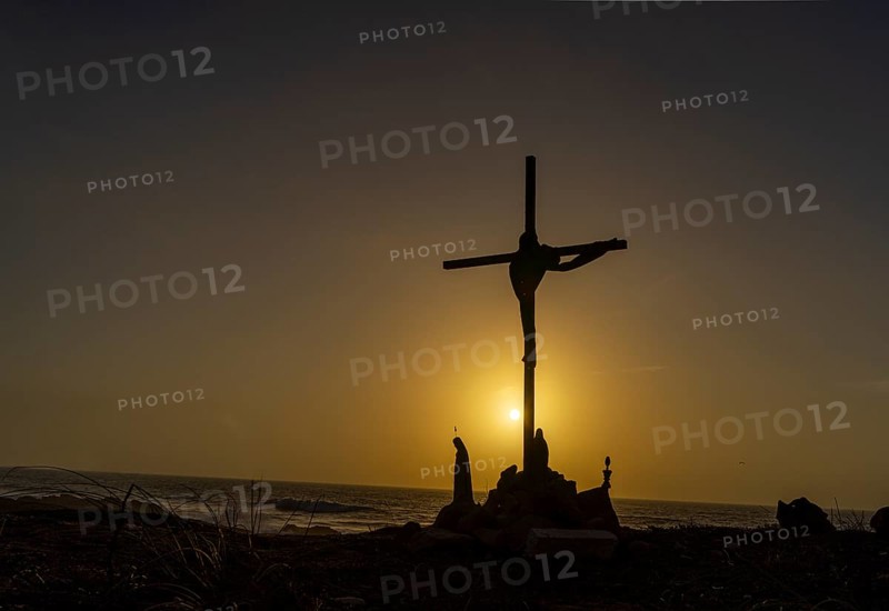 Religious scene, temporary Christian cross on the coast Farol de Cabo Raso lighthouse, SÃ£o Bras de Sanxete fortress, Cascais, Portugal