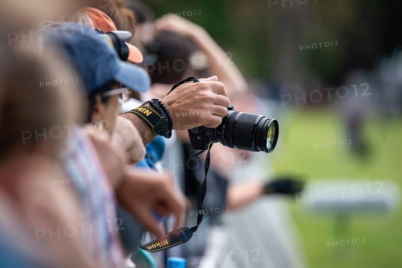 A man's hand holds a Nikon DSLR camera during a sporting event in Buenos Aires, Argentina