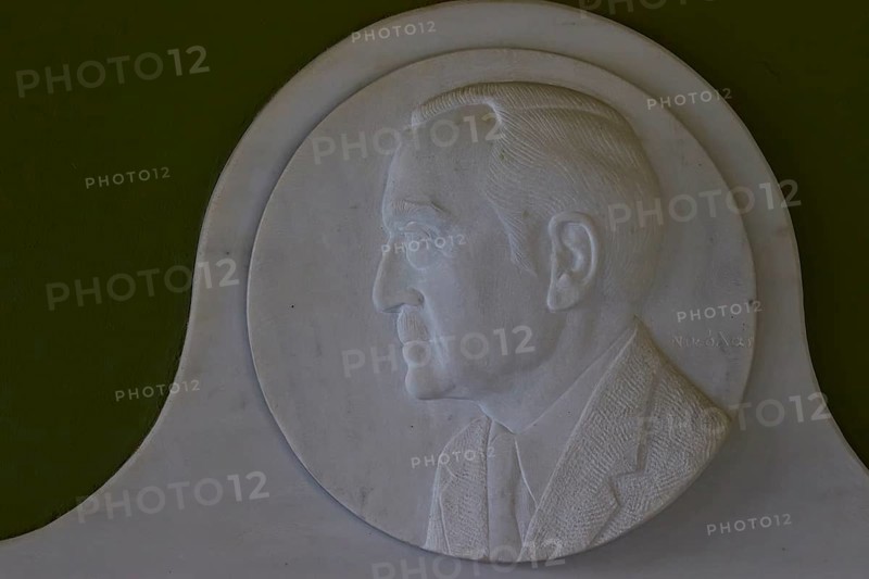Marble relief depicts Rudolph A. Peterson, a sponsor of the Archaeological Museum in Nemea, marble relief of a man in profile on a green background, artfully and classically designed, Archaeological Museum, Nemea, Peloponnese, Greece