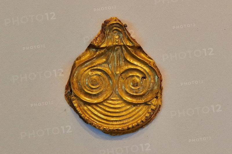 Golden ancient artifact with spiral pattern in teardrop shape, Archaeological Museum, Nemea, Peloponnese, Greece
