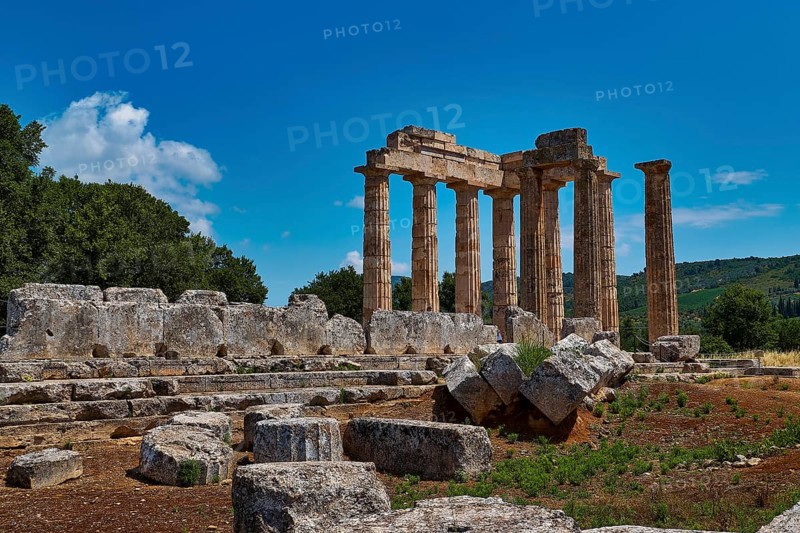 Majestic ancient ruins of a temple with numerous columns and scattered stones, Ancient Sanctuary of Zeus, Archaeological Site, Nemea, Peloponnese, Greece