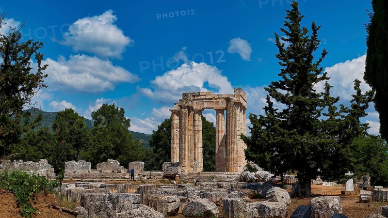 Ancient ruins of a temple surrounded by pine trees and bright blue sky, Ancient Sanctuary of Zeus, Archaeological Site, Nemea, Peloponnese, Greece