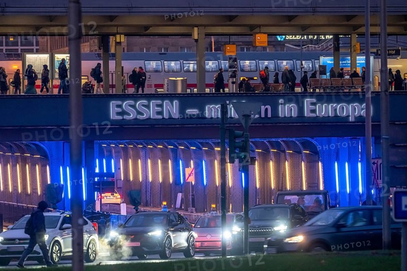 The main train station in Essen, blue-lit underpass, bus station, am Europaplatz, public transport train on the platform, North Rhine-Westphalia, Germany