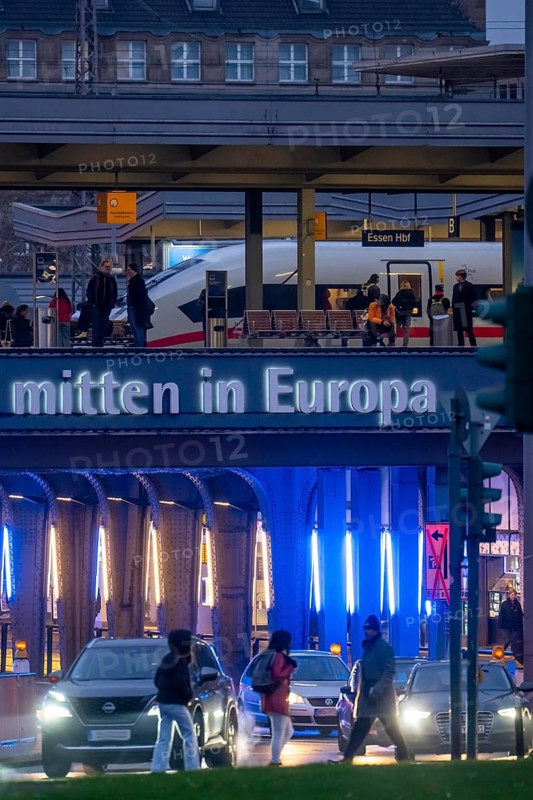 The main train station in Essen, blue illuminated underpass, bus station, am Europaplatz, ICE train on the platform, North Rhine-Westphalia, Germany
