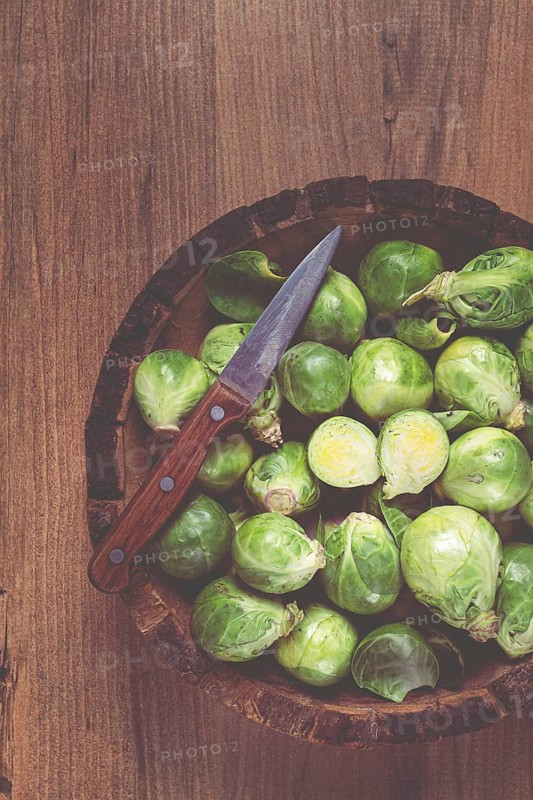 Fresh Brussels sprouts, raw, top view, on a wooden table, no people