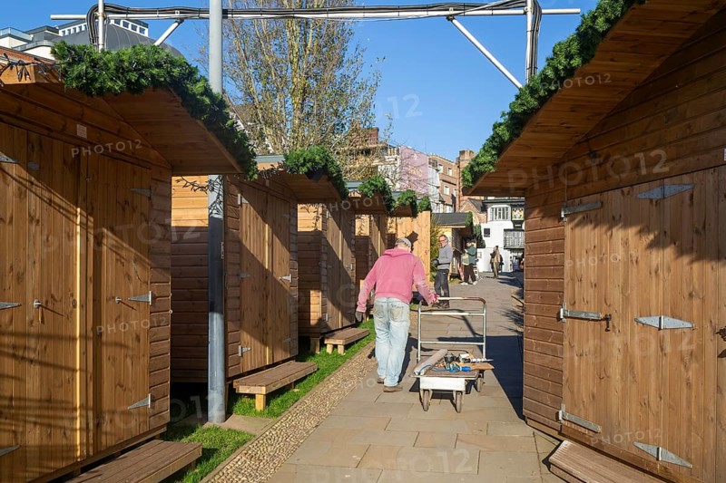 Wooden sheds being prepared for Exeter Cathedral Christmas Market, Exeter, Devon, England, UK