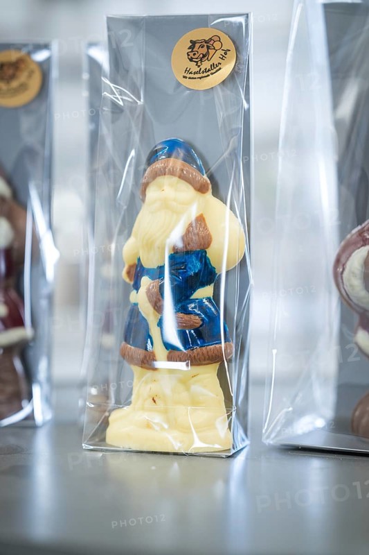 White and blue chocolate Santa Claus figure in transparent packaging on a table, Christmas baking, Haselstaller Hof, Wildberg, Calw district, Germany