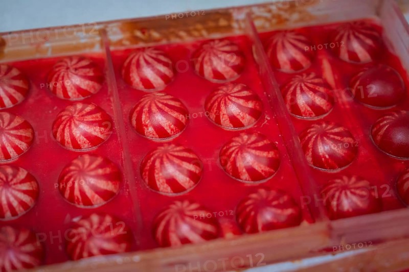 Red chocolate candy with white stripes in a chocolate mold, Christmas baking, Haselstaller Hof, Wildberg, Calw district, Germany