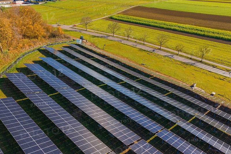 Solar modules in a structured arrangement from an aerial perspective, surrounded by green nature, Bau PV Freifaechenanlage, Weil der Stadt, Germany