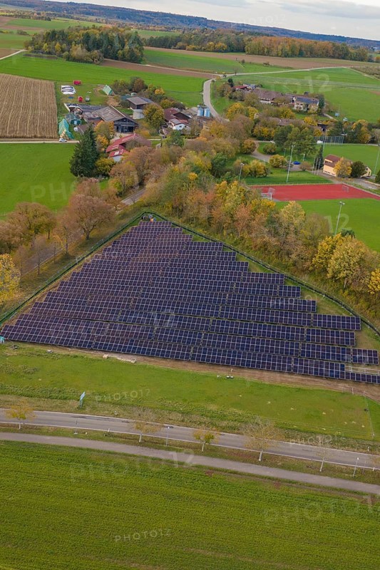 Extensive rural views with solar panels next to a small village, construction of a PV open-air system, Weil der Stadt, Germany