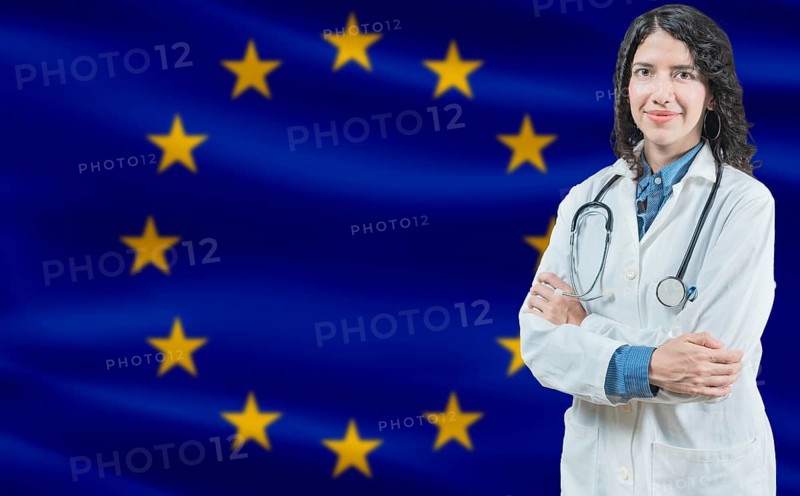 European Union medicine and healthcare concept Doctor close up against European Union flag background