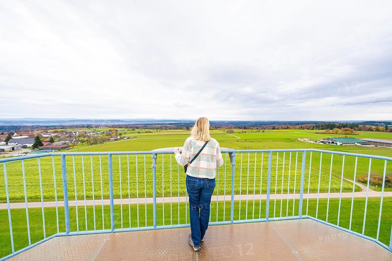 Woman standing on platform looking out over the vast landscape, DÃ¼rrenmettstetten observation tower, Sulz am Neckar, Germany