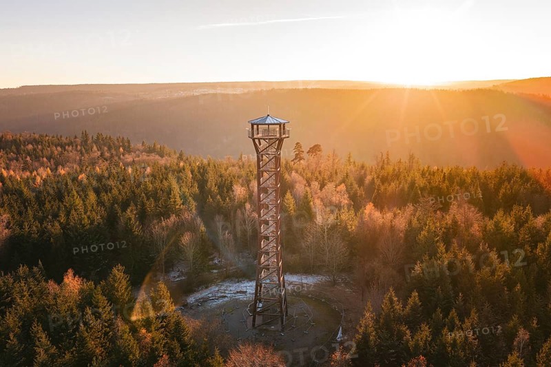 An observation tower stands in an autumnal forest at sunrise, Hohe Warte lookout tower, Hohenwart, Pforzheim, Germany