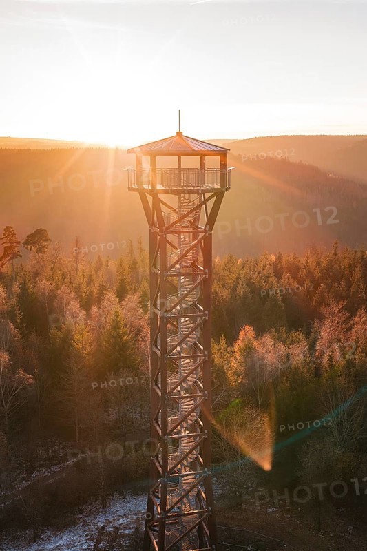 A tower glows in the morning light above the colorful autumn forest, Hohe Warte observation tower, Hohenwart, Pforzheim, Germany