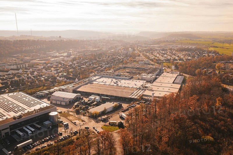 Industrial complex and urban settlements surrounded by autumn vegetation, MÃ¼hlacker, Enzkreis, Germany