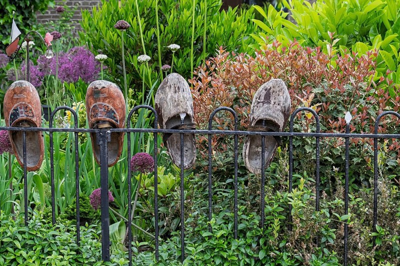 Garden fence with old wooden shoes as decoration, Friesland province, the Netherlands
