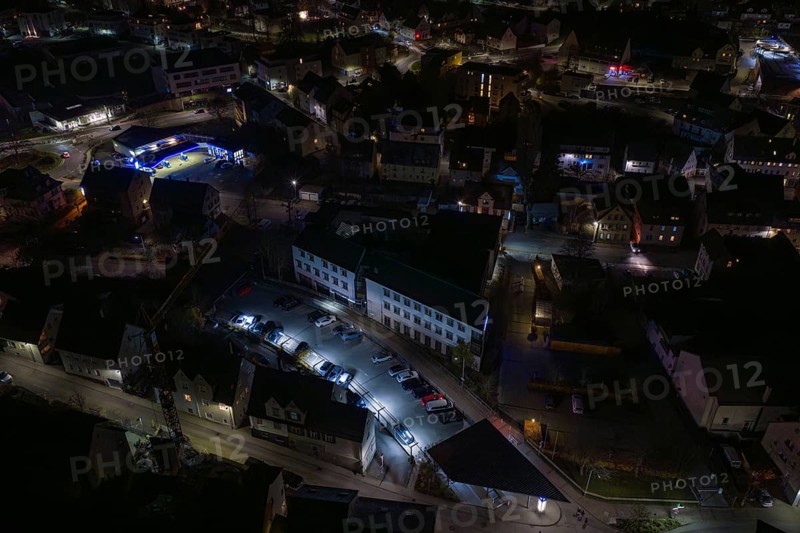 Nighttime view of city roads with parked cars and illuminated buildings, Nagold, Calw district, Germany