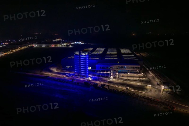 Factory at night with a characteristic blue-lit tower, Nagold, Calw district, Germany
