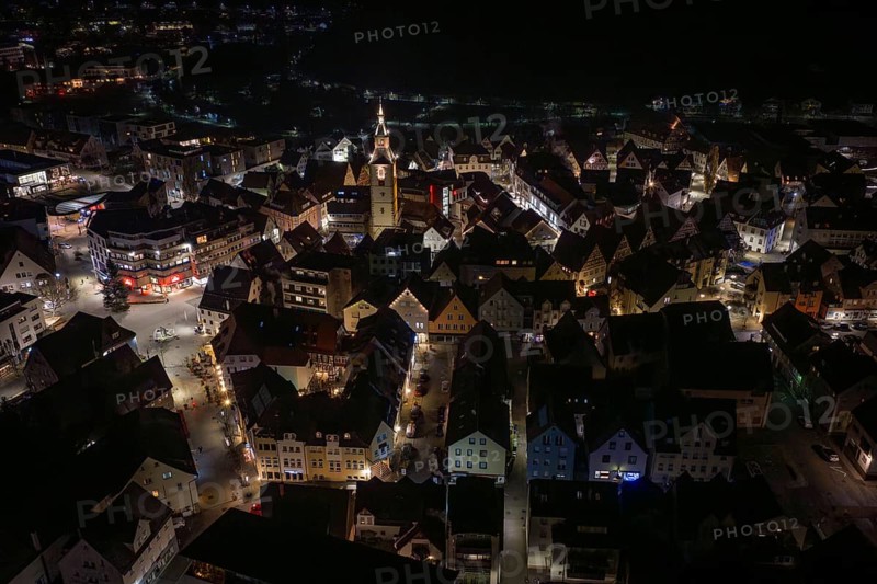 Night panorama of a city with a centrally located, illuminated church tower, Nagold, Calw district, Germany