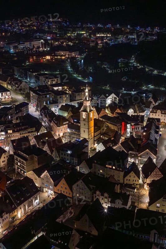 Night view of a city with illuminated buildings and a central church tower, Nagold, Calw district, Germany