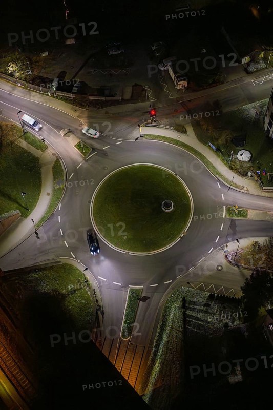 Night view of an illuminated roundabout with passing cars, Nagold, Calw district, Germany