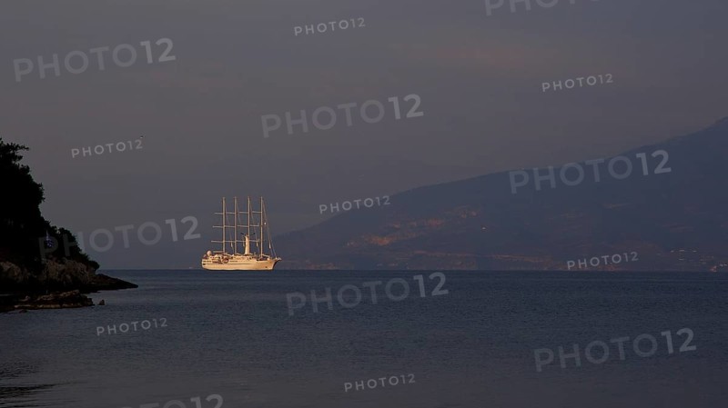 A large sailing ship sails in the calm sea in front of a dark mountain silhouette, Nauplion, Nafplion, Peloponnese, Greece