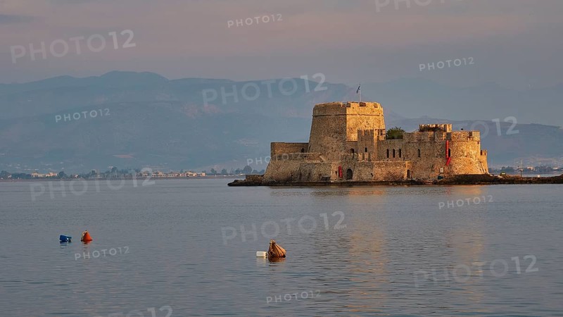 Bourtzi island fortress, tranquil water landscape with a historic castle and buoys in the evening light, Nauplion, Nafplion, Peloponnese, Greece
