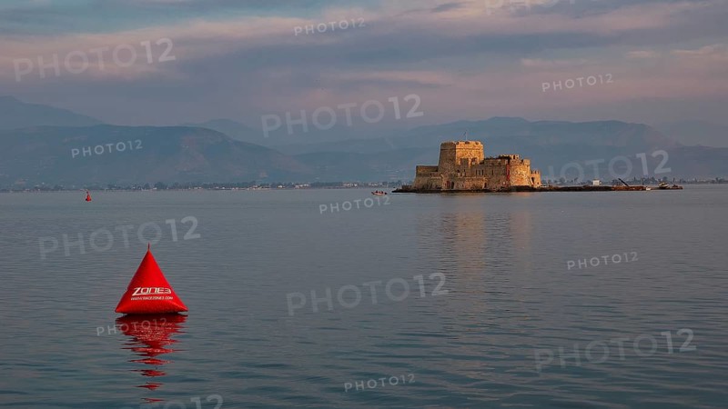 Bourtzi island fortress, historic castle in the evening light on the water with a red buoy, Nauplion, Nafplion, Peloponnese, Greece