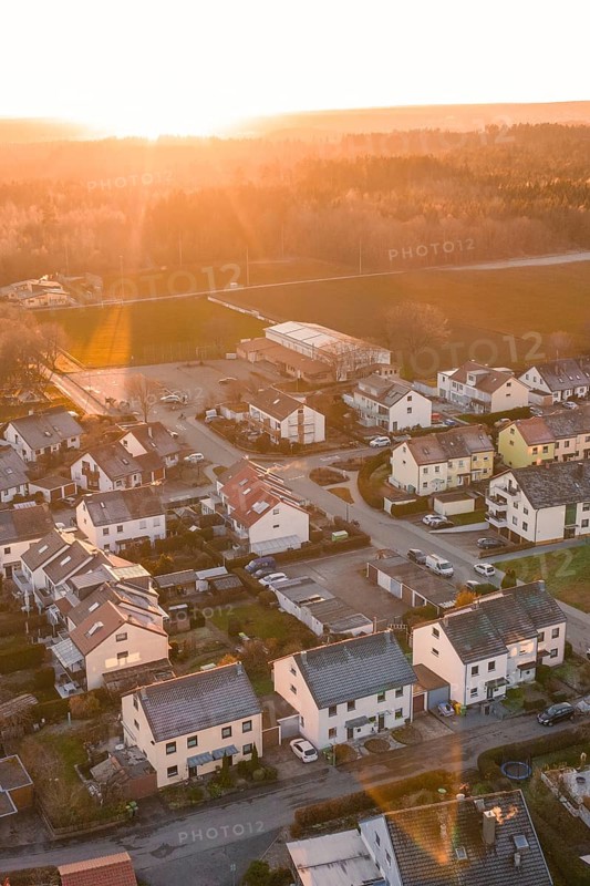 Suburb with houses and streets, illuminated by the evening sun, surrounded by nature, Althengstett, Calw district, Germany