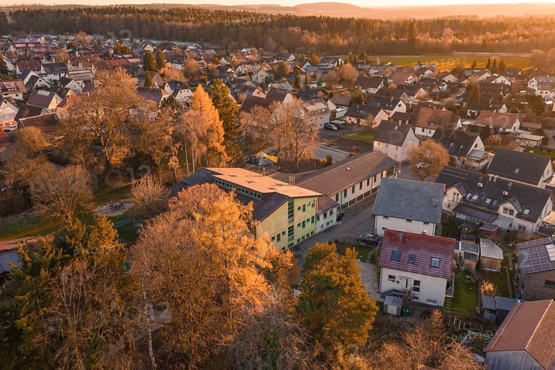 Rural area with houses and autumn trees in a warm evening atmosphere, Althengstett, Calw district, Germany