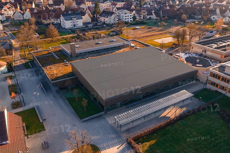 Aerial view of a large, modern building complex with sports facilities and surrounding parking spaces, sports center and swimming pool Althengstett, Calw district, Germany