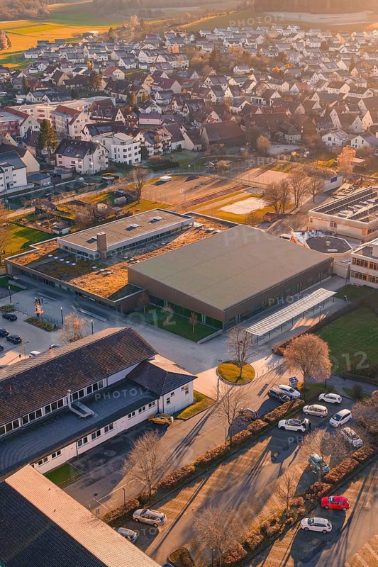 Aerial view of a village at sunset with a view of buildings and autumn colors, Althengstett sports center and swimming pool, Calw district, Germany