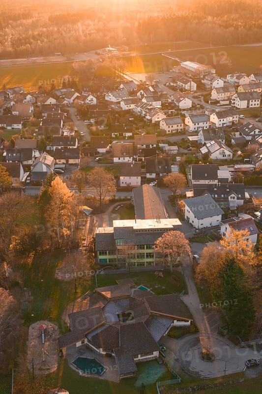 View of residential area from the air with autumn trees and sunset atmosphere, Althengstett, Calw district, Germany