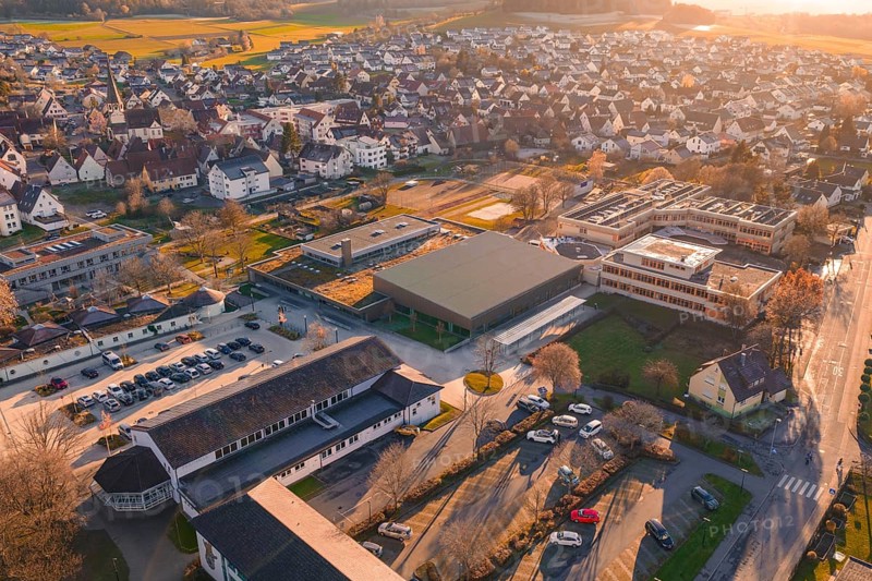 Village visible from above with sunset, roofs and surrounding landscape, Althengstett sports center and swimming pool, Calw district, Germany