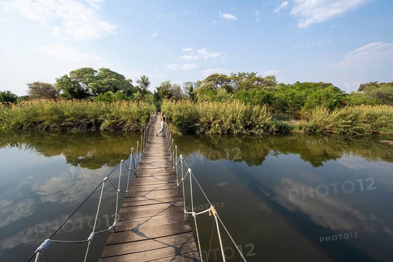 Toruist on the Kavango River, suspension bridge at Camp Kwando, Zambezi region, Caprivi Strip, Namibia