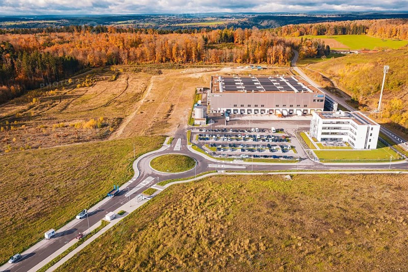 Industrial complex with roundabout, surrounded by forest and empty fields in an autumn environment, new Lindenrain industrial park, Calw, Black Forest, Germany