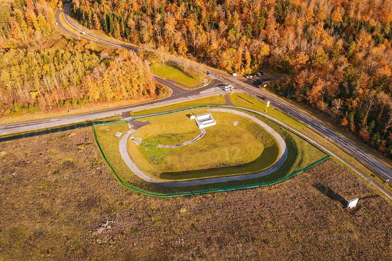 Test site with surrounding forest and road junction in autumn landscape, new Lindenrain industrial park, Calw, Black Forest, Germany