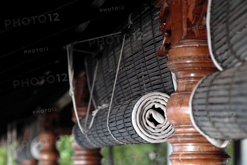 Close-up view of rolled bamboo blinds and artfully turned wooden posts, Heritage Hotel Privacy, Vembanad Lake, Kerala, India