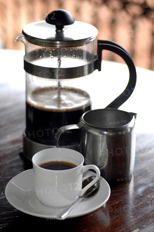 French coffee press next to a cup of coffee and a milk jug on a table, Serenity boutique hotel, Malabar Escapes, Kerala, India