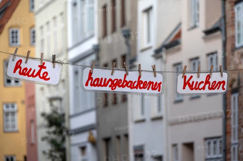 Home-baked cake today, signs on a clothesline across the street, Hanseatic City of LÃ¼beck, Schleswig-Holstein, Germany