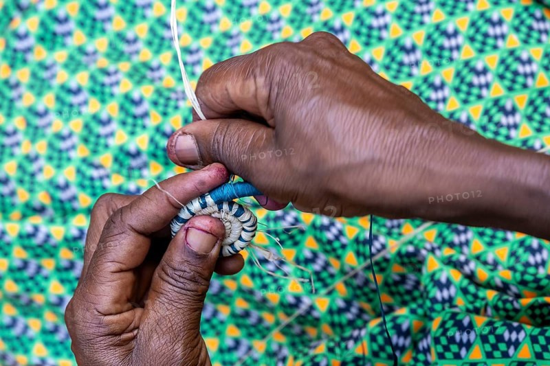 Local woman weaving baskets from papyrus, near Fort Portal, Uganda