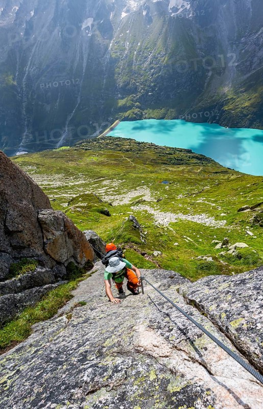 Mountaineer climbs on the secured Schijen-ZwÃ¤rg via ferrata, climb to BergseehÃ¼tte, Göscheneralp in the back, Canton of Uri, Switzerland