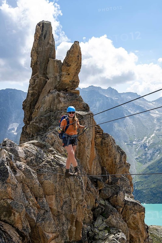 Crocodile rock formation, mountaineer on rope bridge in the Crocodile Mountain Lake via ferrata on Bergseeschijen-Vorbau, Göscheneralp, Canton of Uri, Switzerland